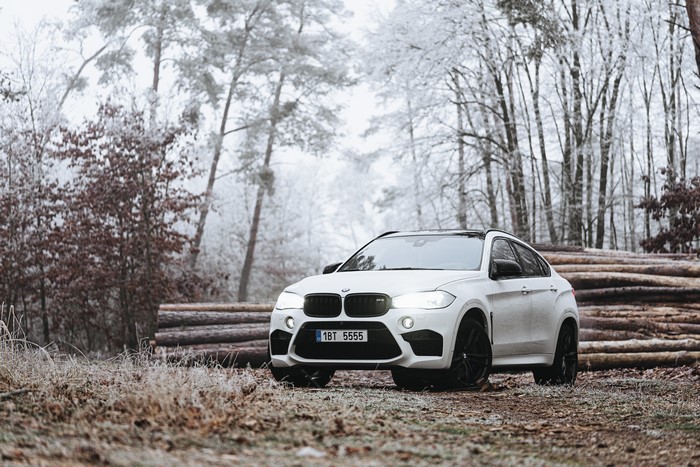 White BMW X6M in a Winter Forest