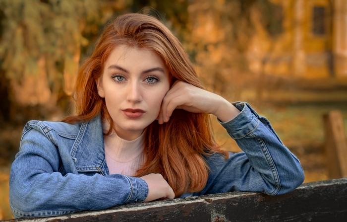 Redhead girl with blue eyes in denim jacket