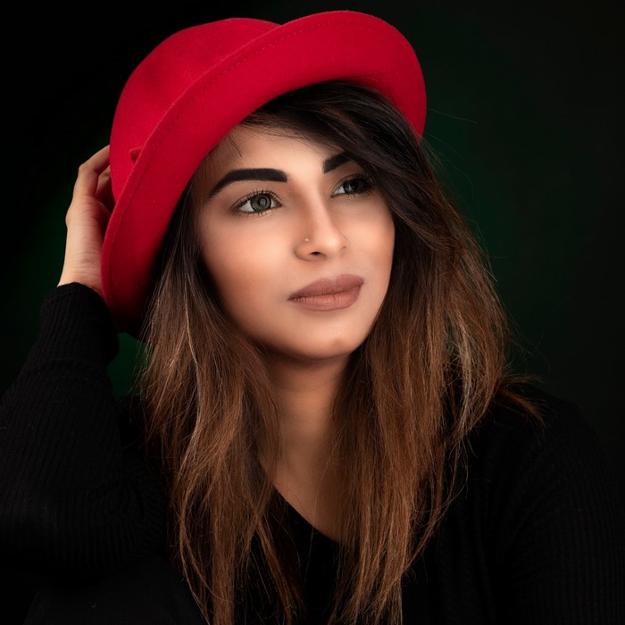 Woman in red hat and black sweater