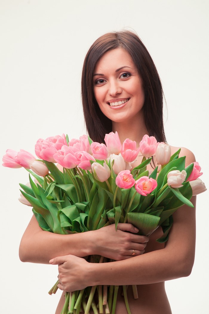 Woman holding a bouquet of pink tulips