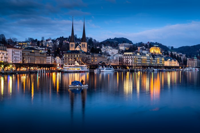 Lucerne cityscape with church spires and lake at dusk
