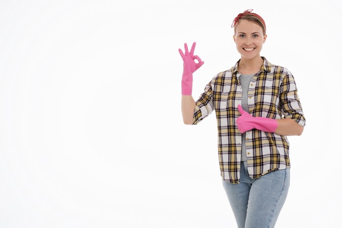 Woman in Plaid Shirt and Pink Gloves Making OK Gesture