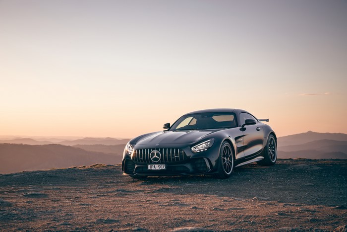 Black Mercedes-Benz GT R Coupe on Mountain Overlook at Sunset