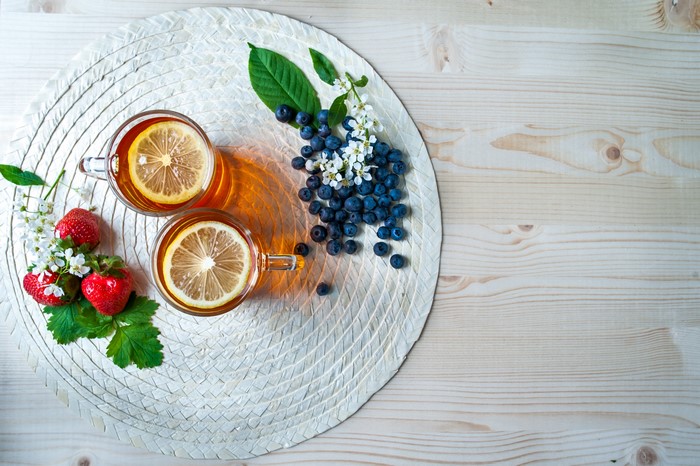 Tea with Lemon, Strawberries, and Blueberries on a Placemat