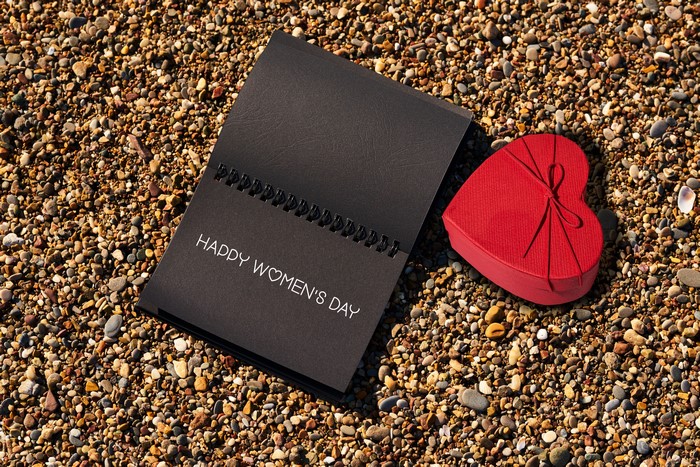 Happy Women's Day notepad and heart gift on stones