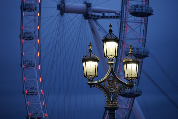 Street lights in front of the London Eye at dusk