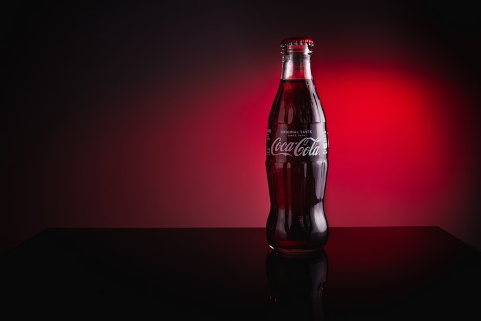 Coca-Cola bottle on a reflective surface