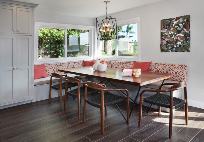 Dining room with banquette seating and modern chandelier