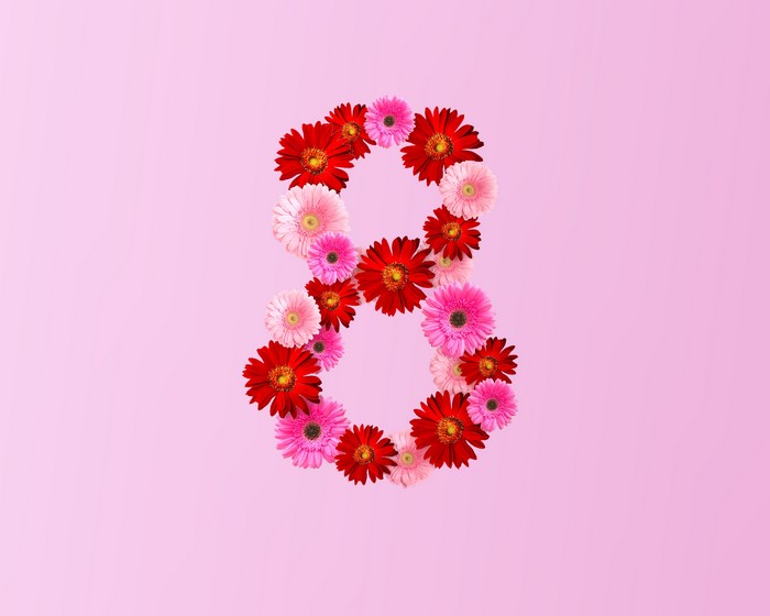 Number 8 made of Gerberas on pink background