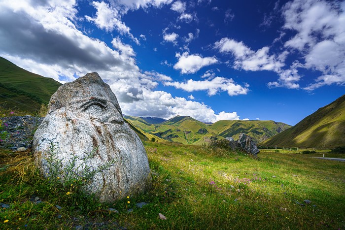 Stone with carved face in Upper Svaneti, Georgia