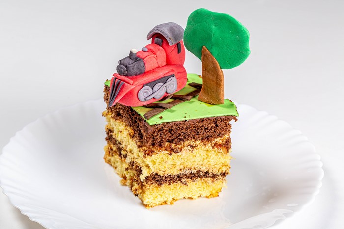 Slice of cake with train decoration