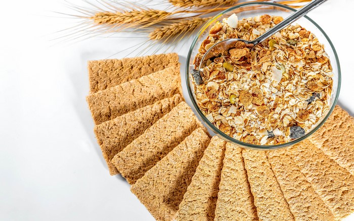 Crispbread and Muesli in a Bowl with Wheat Stalks