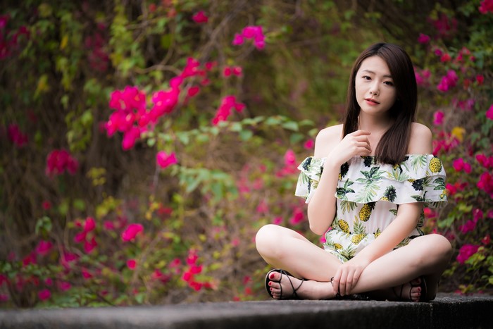 4K Asian Woman Sitting with Bokeh Flowers