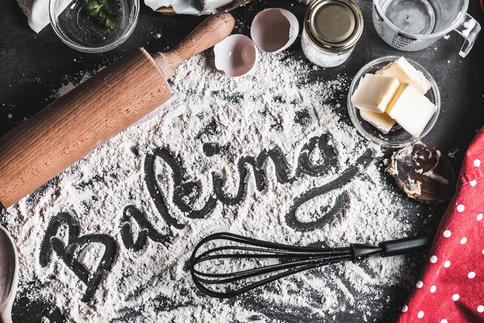 Baking ingredients and word art on a dark surface
