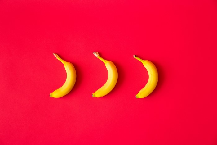 Three Bananas on Red Background