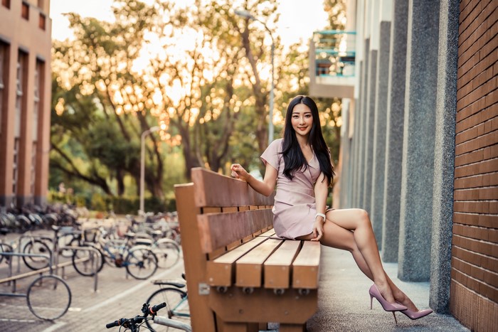 4K Asian Woman Sitting on Bench in Dress
