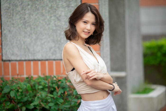 Asian woman with brown hair posing