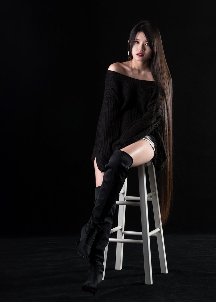 Asian Woman Sitting on Chair Wearing Boots