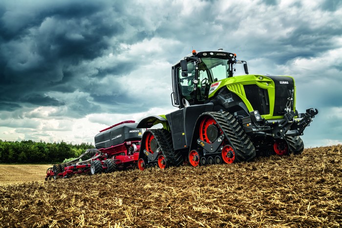 Claas Xerion 5000 tractor with seeder in a field