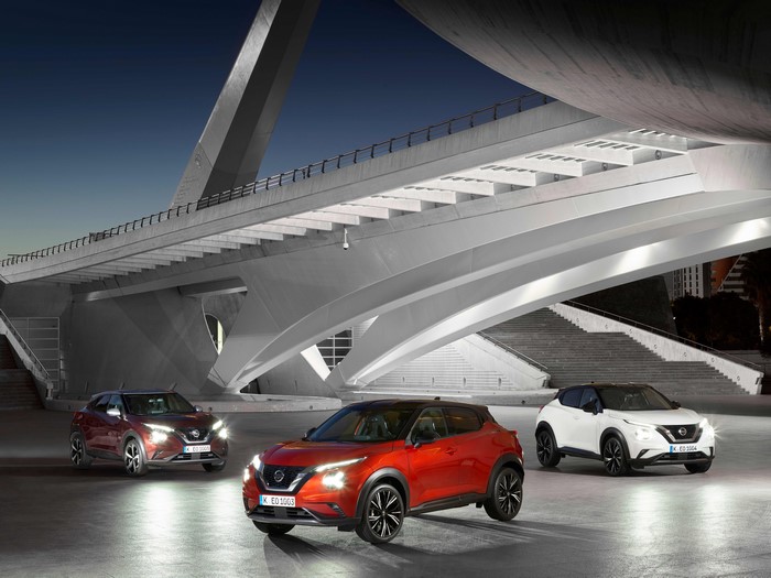 Three Nissan Juke cars under a modern bridge