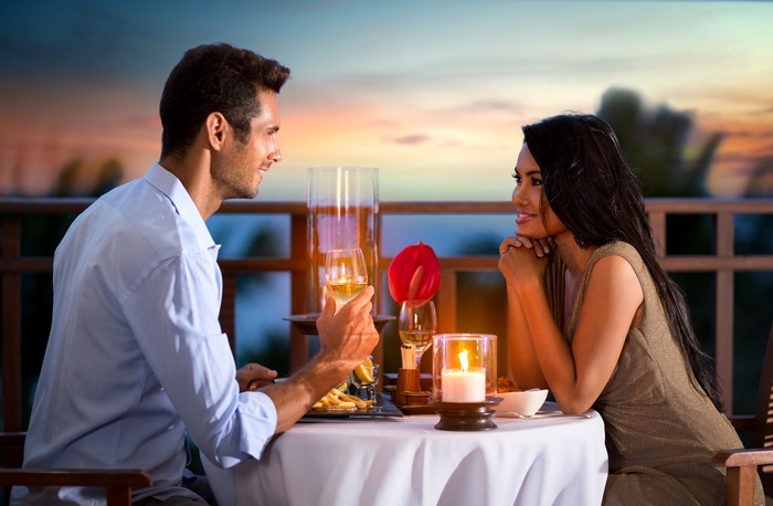 Couple Dining by Candlelight at Sunset