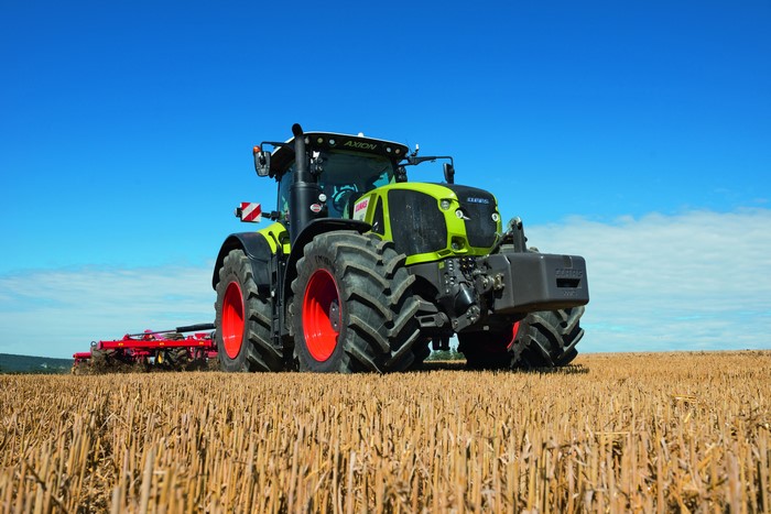Claas Axion 950 tractor plowing a field