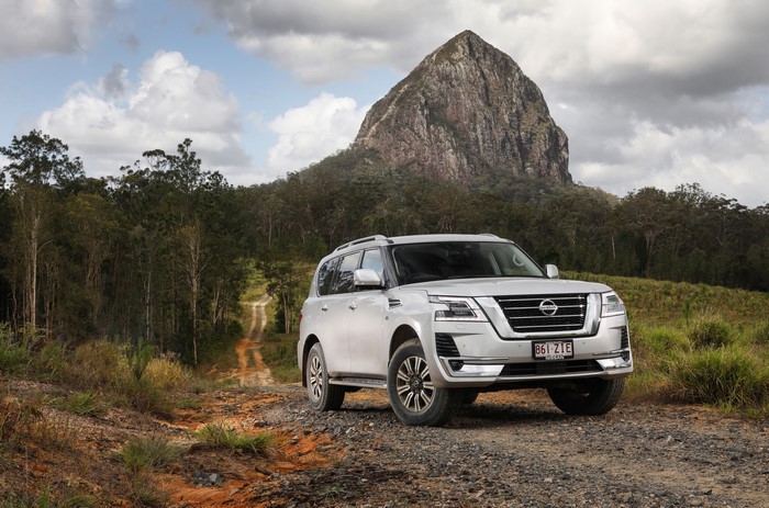 Nissan Patrol Ti-L SUV on a dirt road with a mountain
