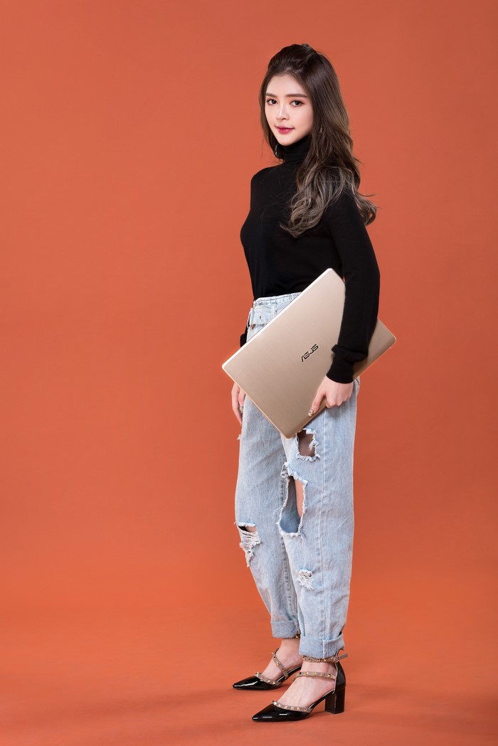 Woman holding an ASUS laptop
