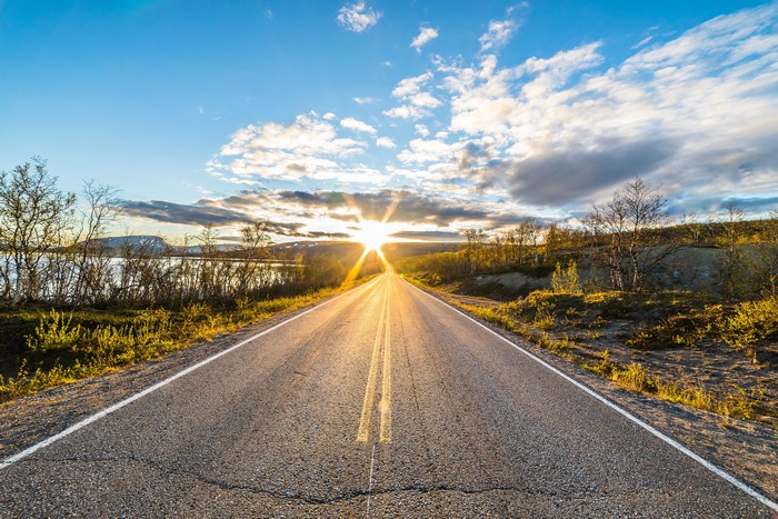 Road in Lapland, Finland during sunrise