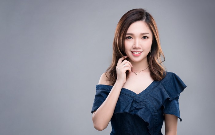 Asian woman with brown hair in a blue dress