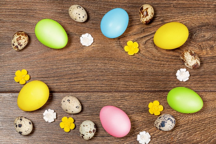 Easter eggs and flowers on wood planks