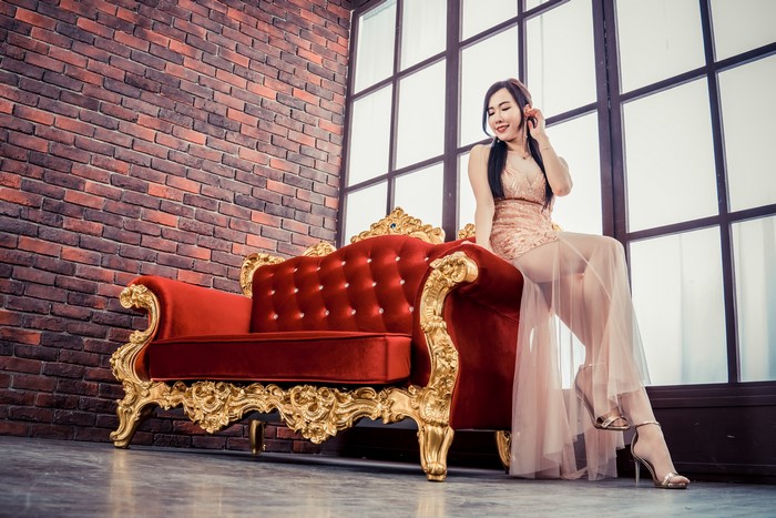 4K Asian Woman Sitting on Ornate Sofa