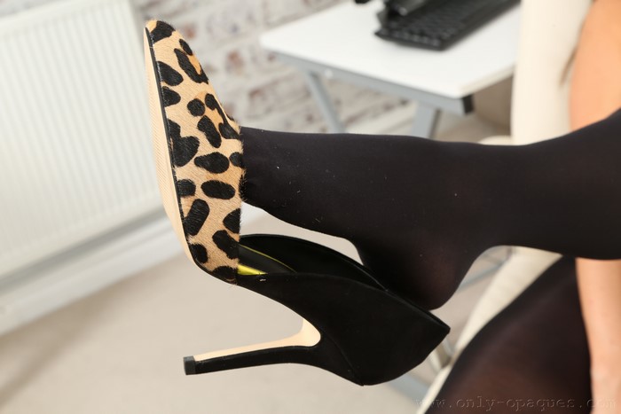 Closeup of woman's legs in pantyhose and stilettos