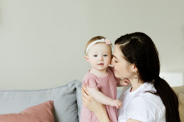 Mother kissing her baby girl