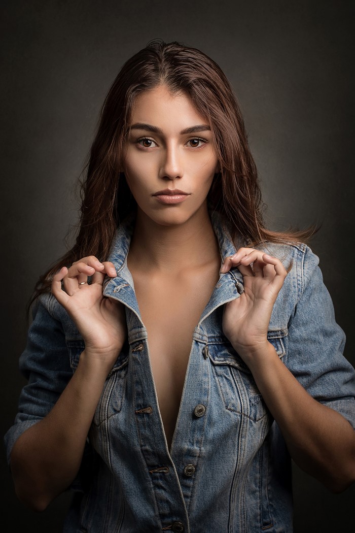 Woman in denim jacket looking at the camera