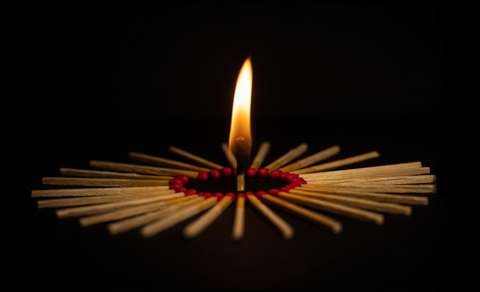 Burning matches arranged in a heart shape