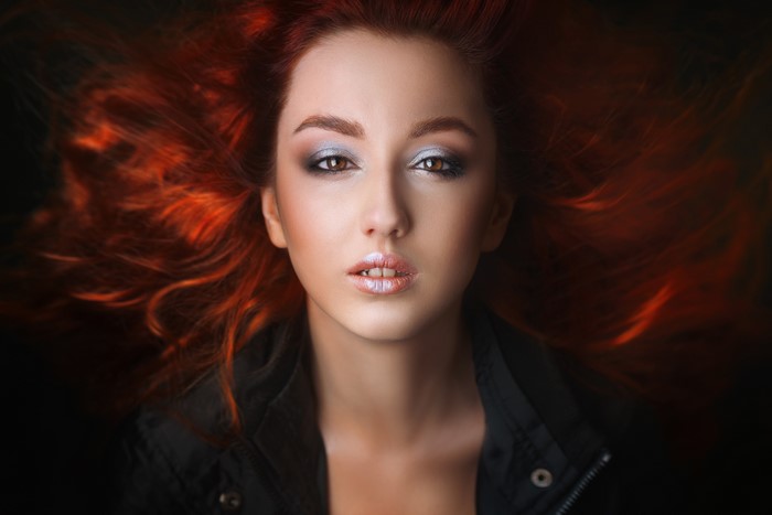 Redhead girl with dramatic makeup and flowing hair