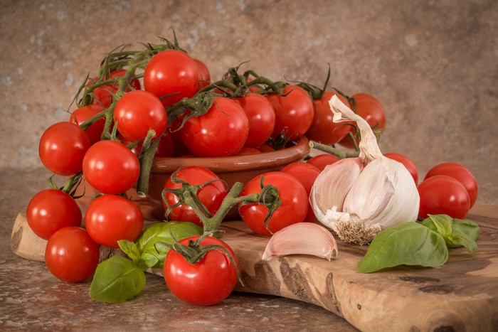 Tomatoes and Garlic on a Cutting Board
