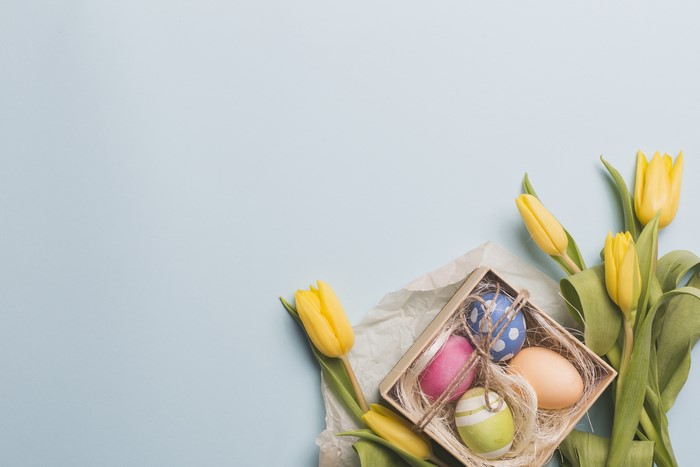 Easter Eggs and Yellow Tulips on Gray Background
