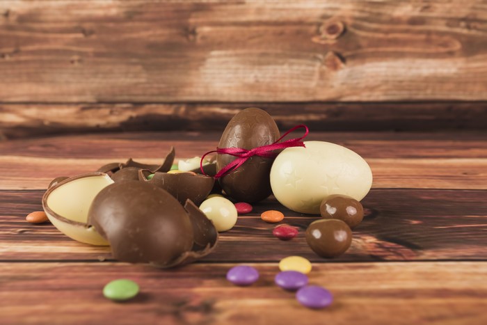 Easter chocolate eggs and candies on wooden planks