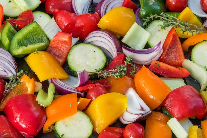 Close-up of chopped vegetables including bell peppers, onions, and zucchini