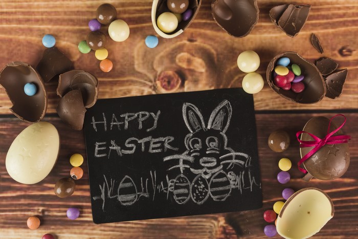 Easter chocolate eggs and candies on wood