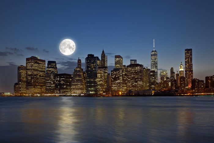 New York City skyline at night with the moon