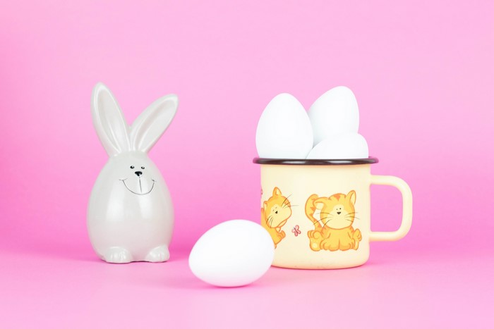 Easter bunny figurine with eggs in a mug