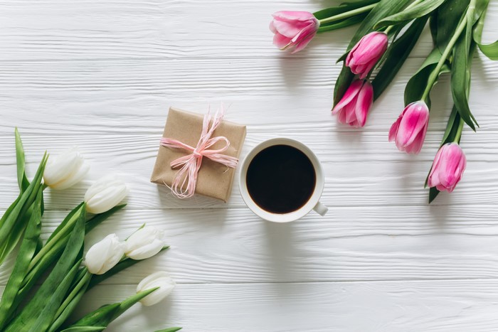 Coffee, Tulips, and Gift on Wood Planks