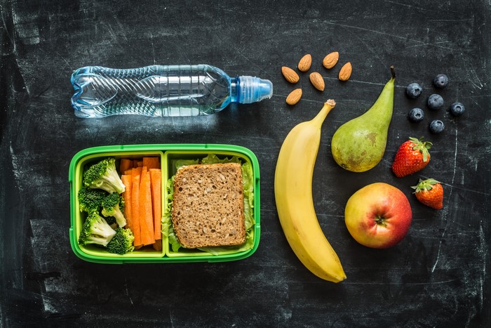 Healthy Lunchbox with Fruits, Vegetables, Nuts, and Water