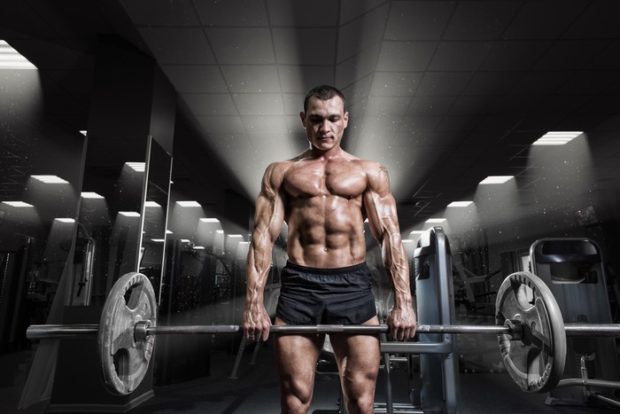 Man lifting barbell in gym