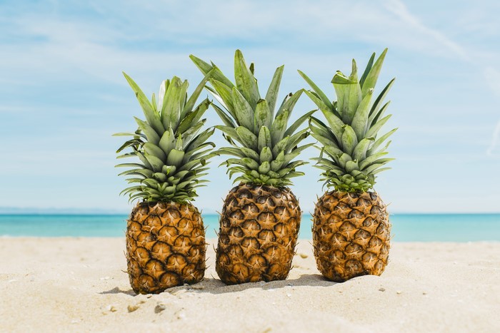Three Pineapples on a Sandy Beach