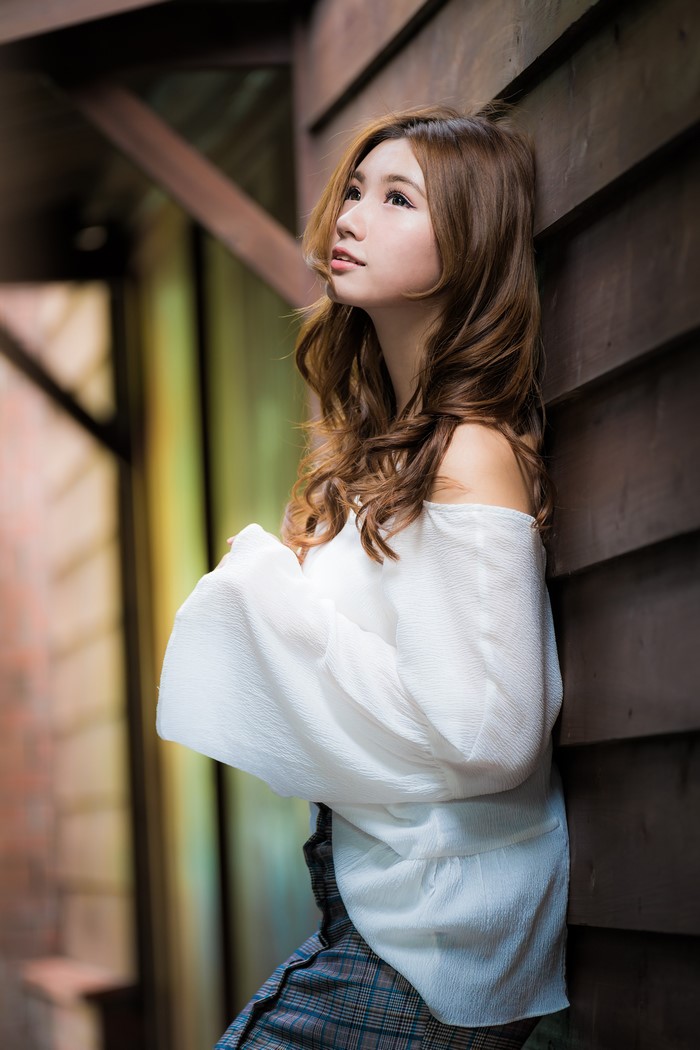 Asian woman with brown hair in a white blouse
