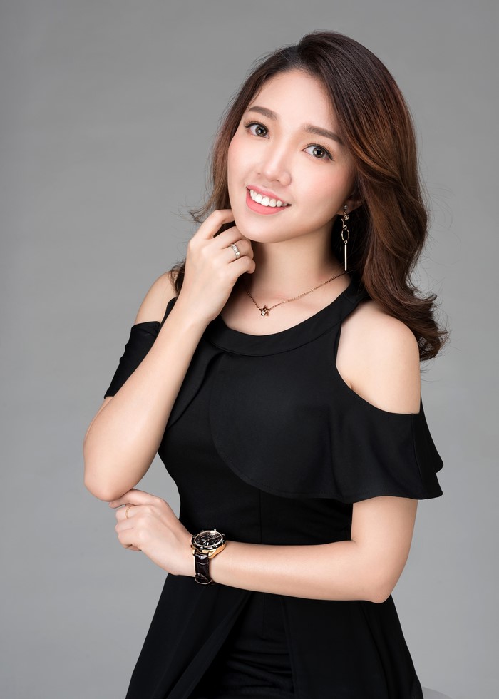 Asian woman in black dress with jewelry